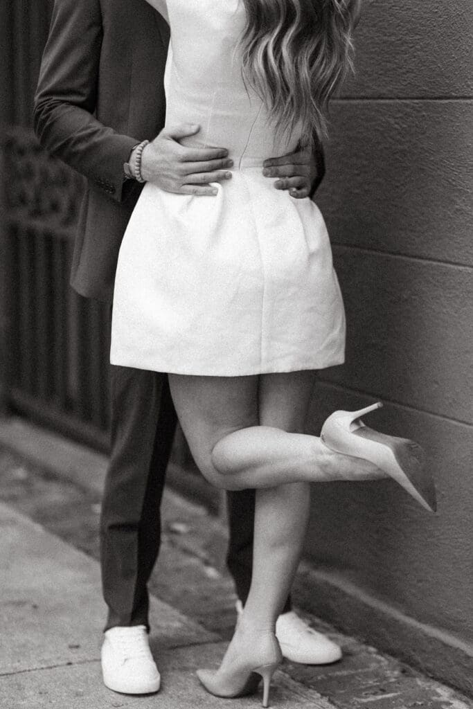 Black and white portrait focuses on a couple’s affectionate embrace and elegant attire, capturing the refined feeling couples often seek in romantic wedding venues Charleston SC.